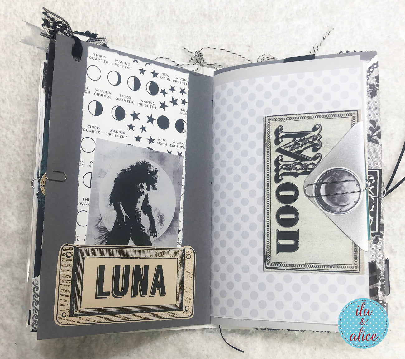 Handmade junk journal with full moon and hare, with decorative pages featuring celestial designs and the name 'Luna'.