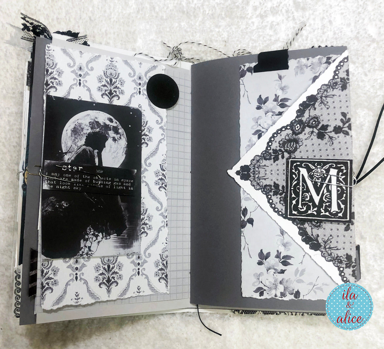 Handmade junk journal with full moon and hare, with decorative pages and a black and white illustration of a moonlit scene.