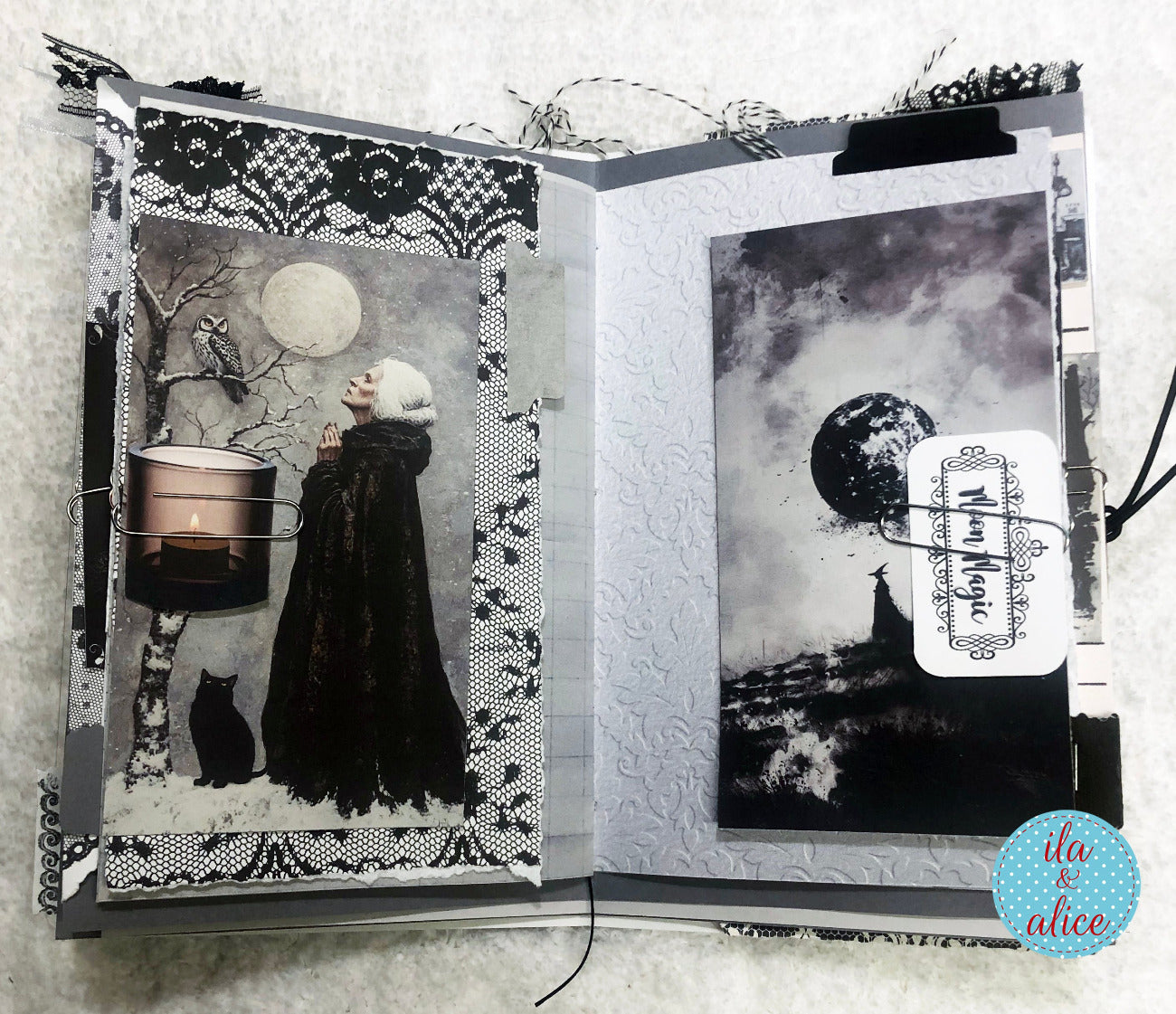 Open book with black and white illustrations of a woman, cat, and moon, with 'Witch of Magic' tag.