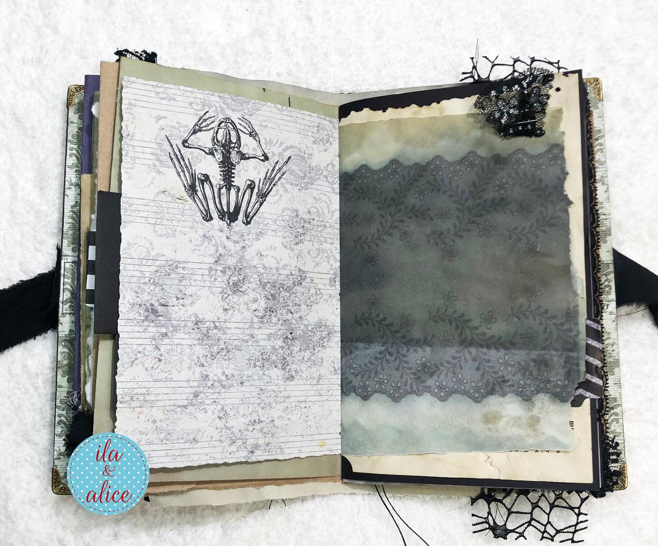 Handmade Eerie Halloween Gothic junk journal with artistic illustrations and text on a textured surface