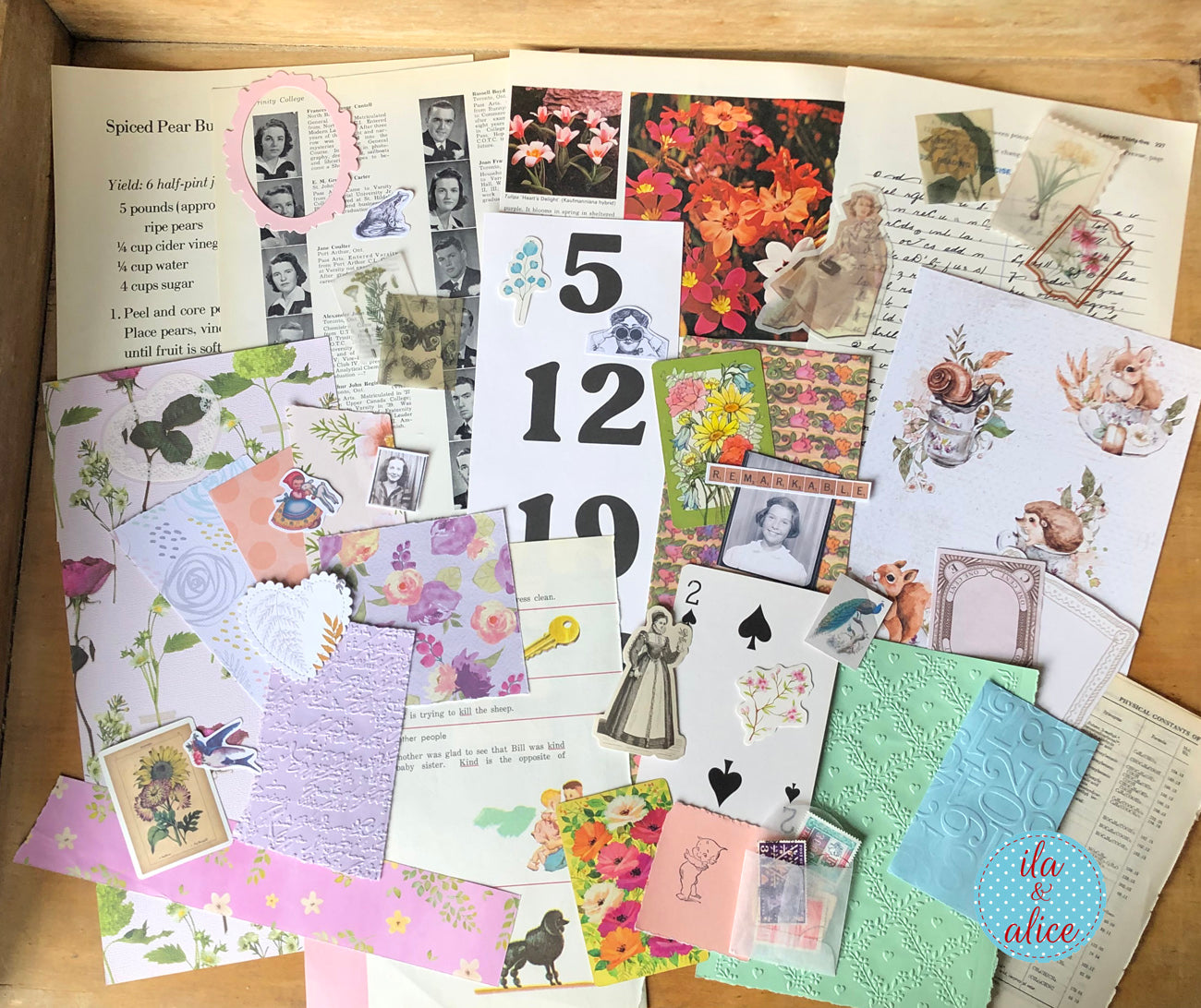 Collection of vintage-style greeting cards and paper with floral and portrait designs on a wooden surface.