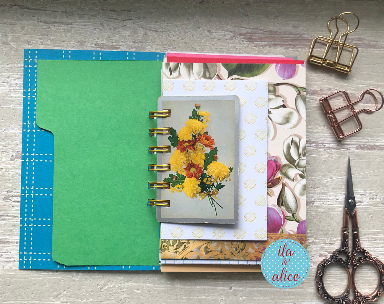 Floral planner on a wooden surface with stationery items