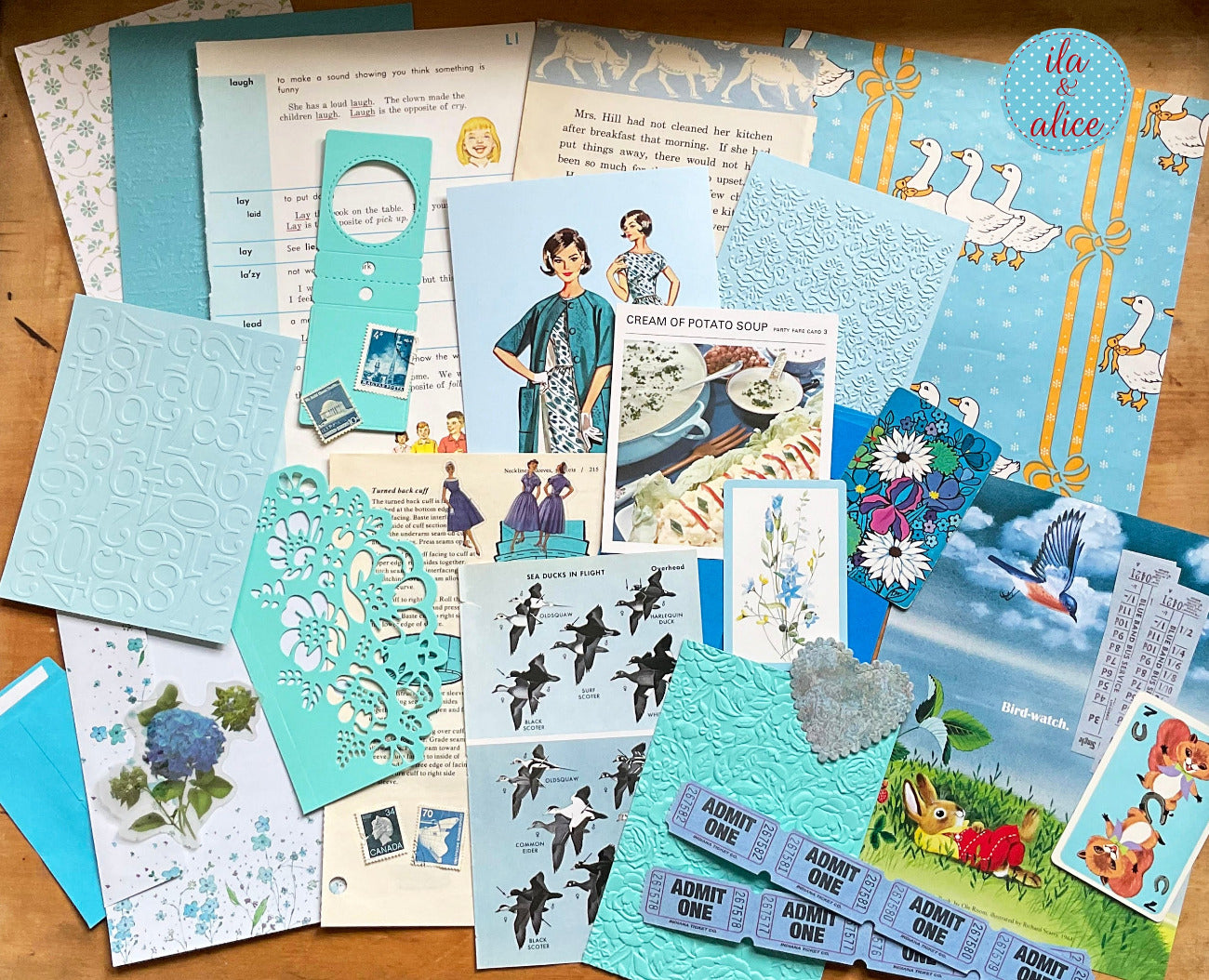 Curated 8x12 junk journal ephemera pack with layered papers, botanical elements, and tuck-able pieces. Blue theme.