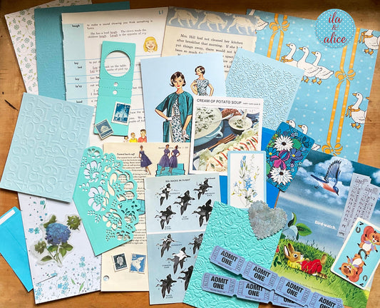 Curated 8x12 junk journal ephemera pack with layered papers, botanical elements, and tuck-able pieces. Blue theme.