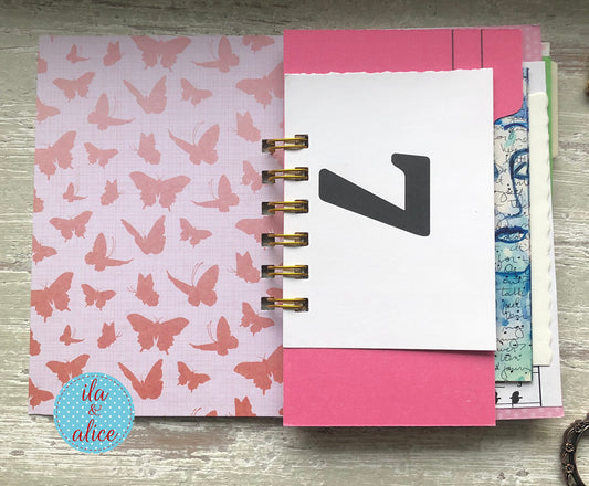 Planner with butterfly design on cover and pink and white pages.