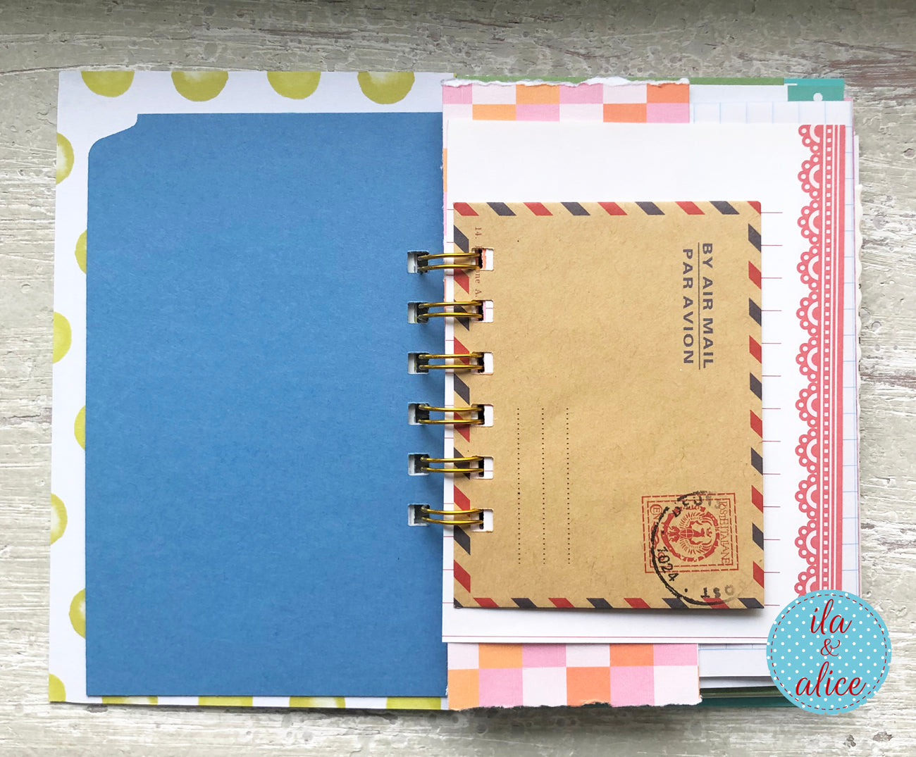 Notebook with colorful pages and a visible brand logo on a wooden surface