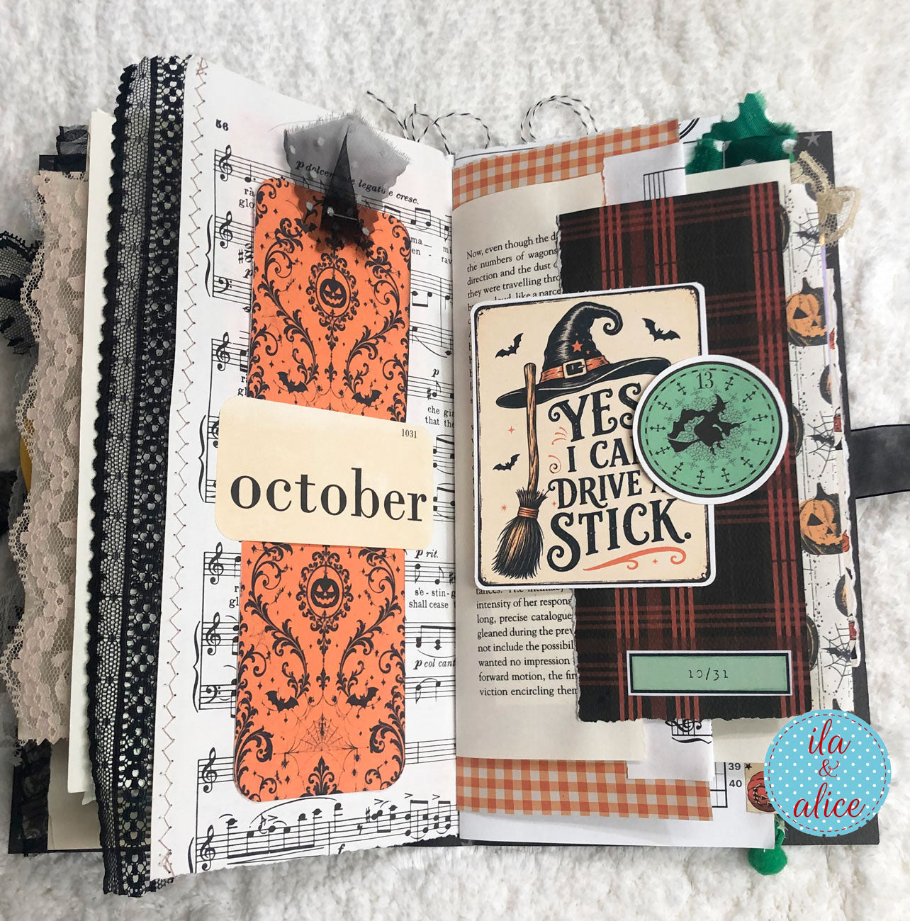 An open handmade scrapbook journal or art journal featuring a Halloween-themed October layout. The pages are decorated with orange patterned paper, black-and-white gingham, a witch hat sticker, a broomstick illustration, a green clock, jack-o'-lanterns, musical notes, and the words 'october' and 'yes I can drive stick'.