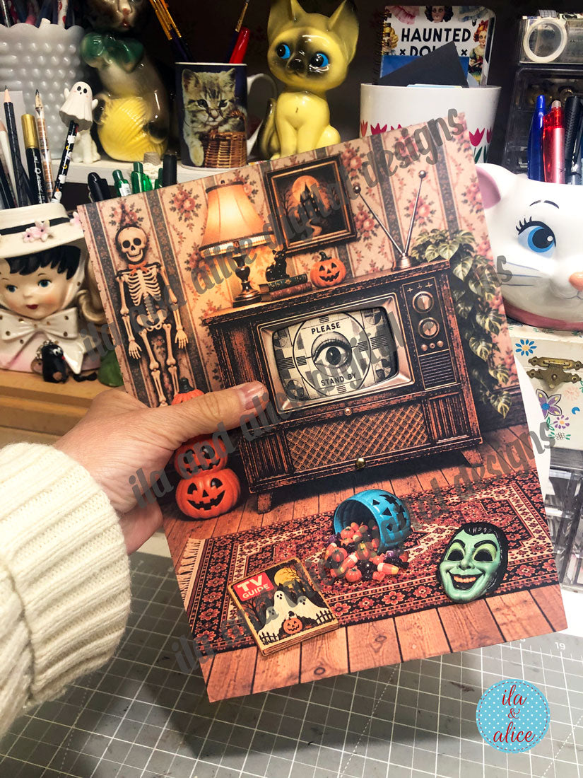 Finished Haunted TV interactive paper project held by hand in the ila & alice studio.