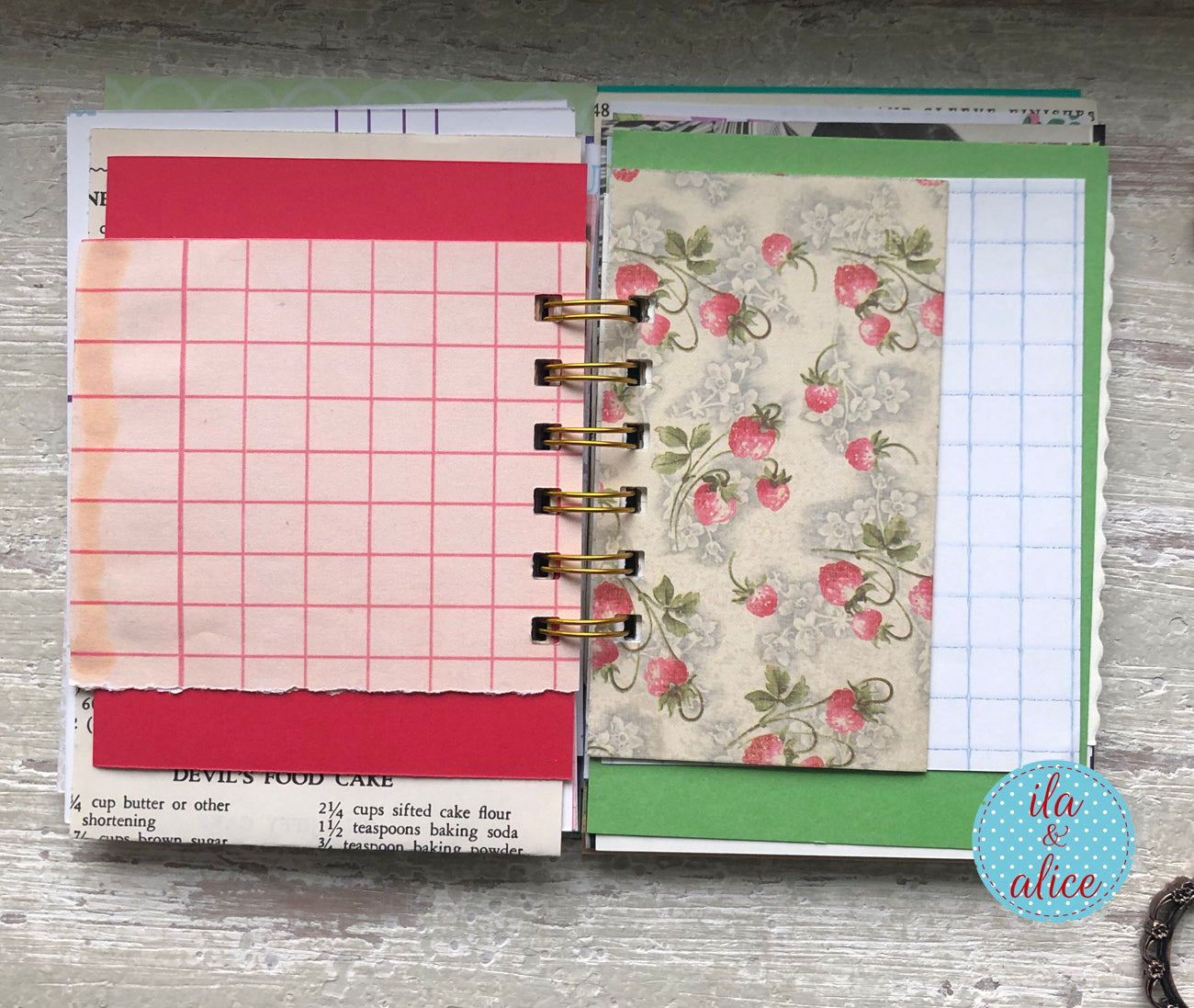 Two spiral-bound planners with different designs on a wooden surface.