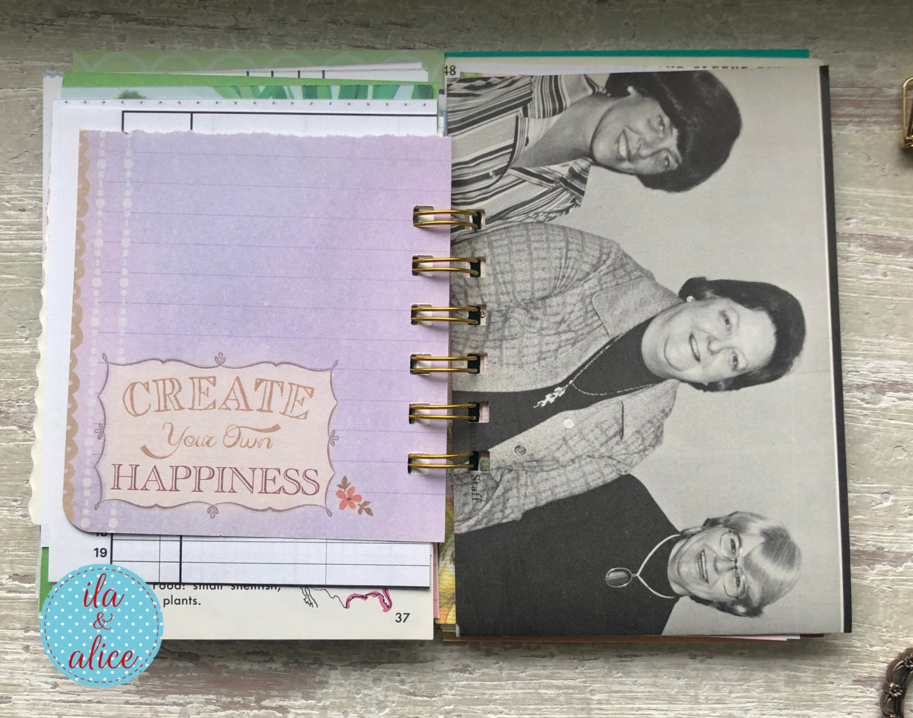 Open planner with a photo of two people and a motivational quote on a wooden surface.