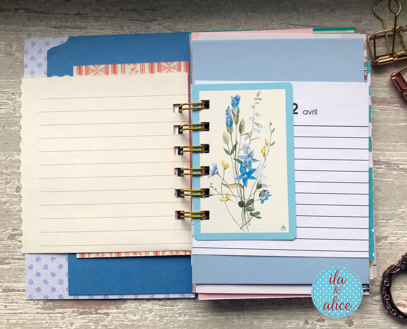 Planner with floral bookmark and colourful tabs on a wooden surface