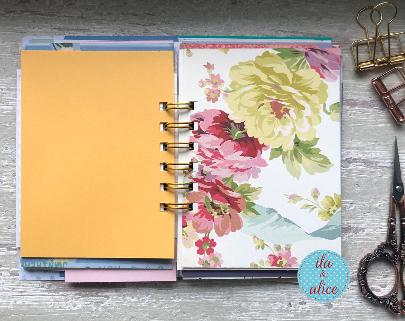 Floral design planner on a wooden surface with office supplies