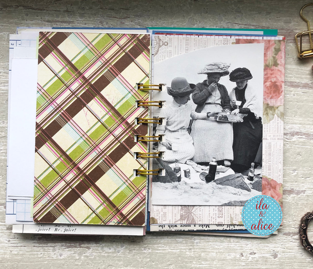 Planner with plaid cover and vintage photo page on a wooden surface