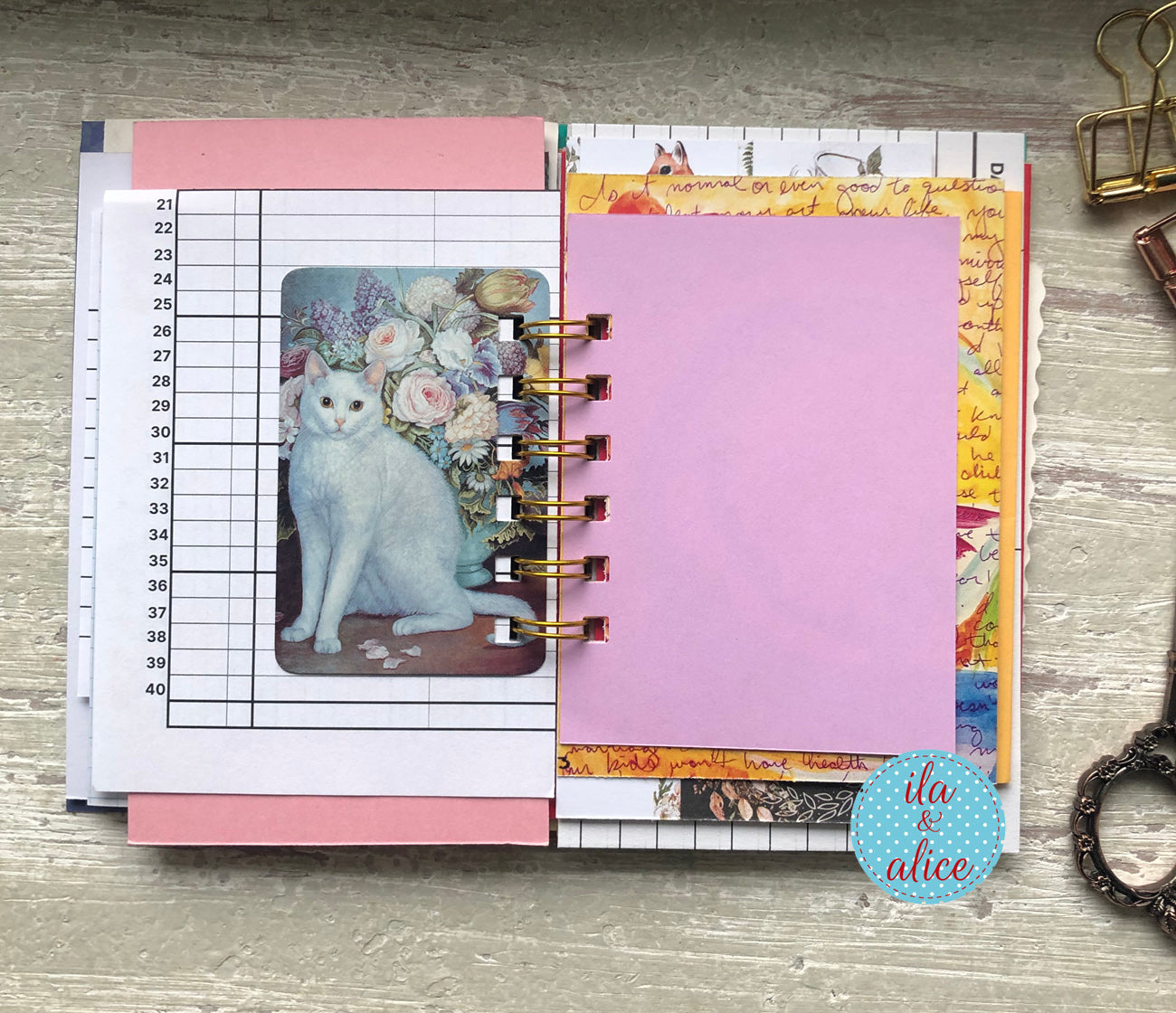 Planner with floral design and cat illustration on a wooden surface