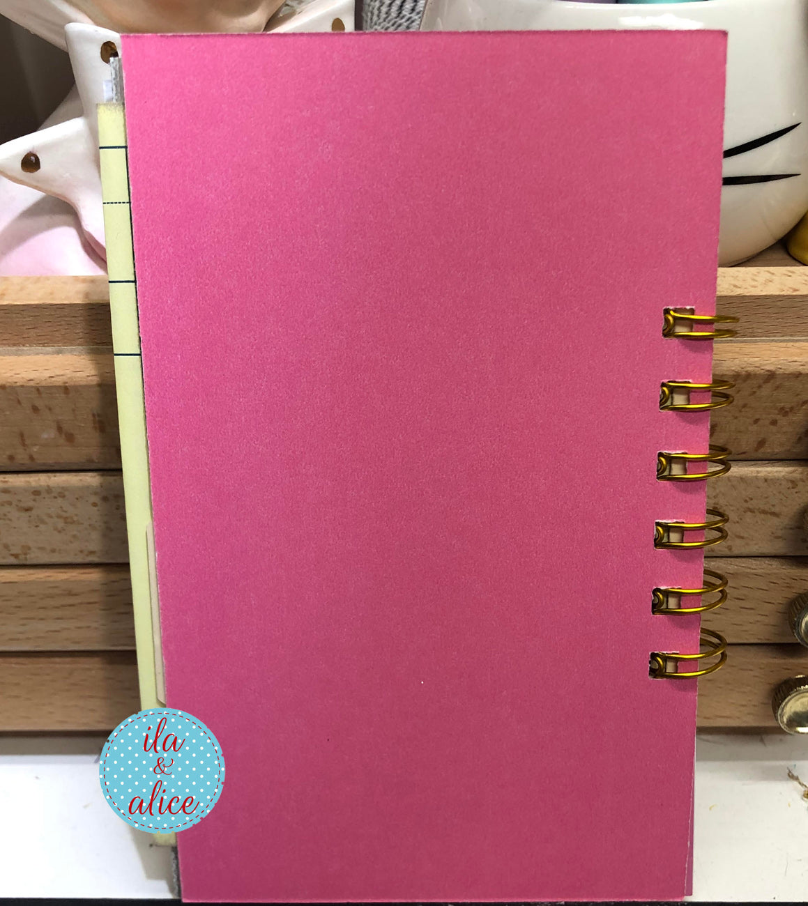 Mini junk journal inside page with layered vintage-inspired papers-back of journal is pink card stock