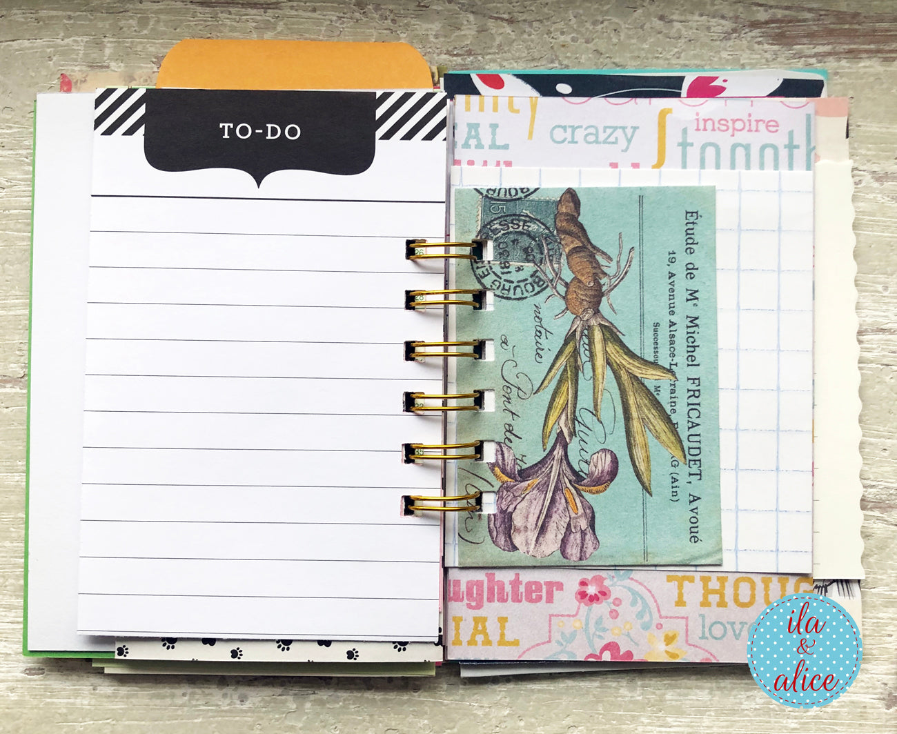 Planner with to-do list and decorative cover on a wooden surface