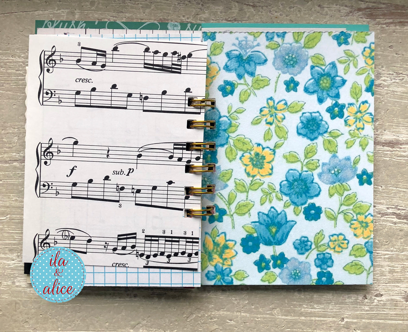 Mini handmade junk journal with vintage fashion illustration on orange polka dot background, spiral bound notebook