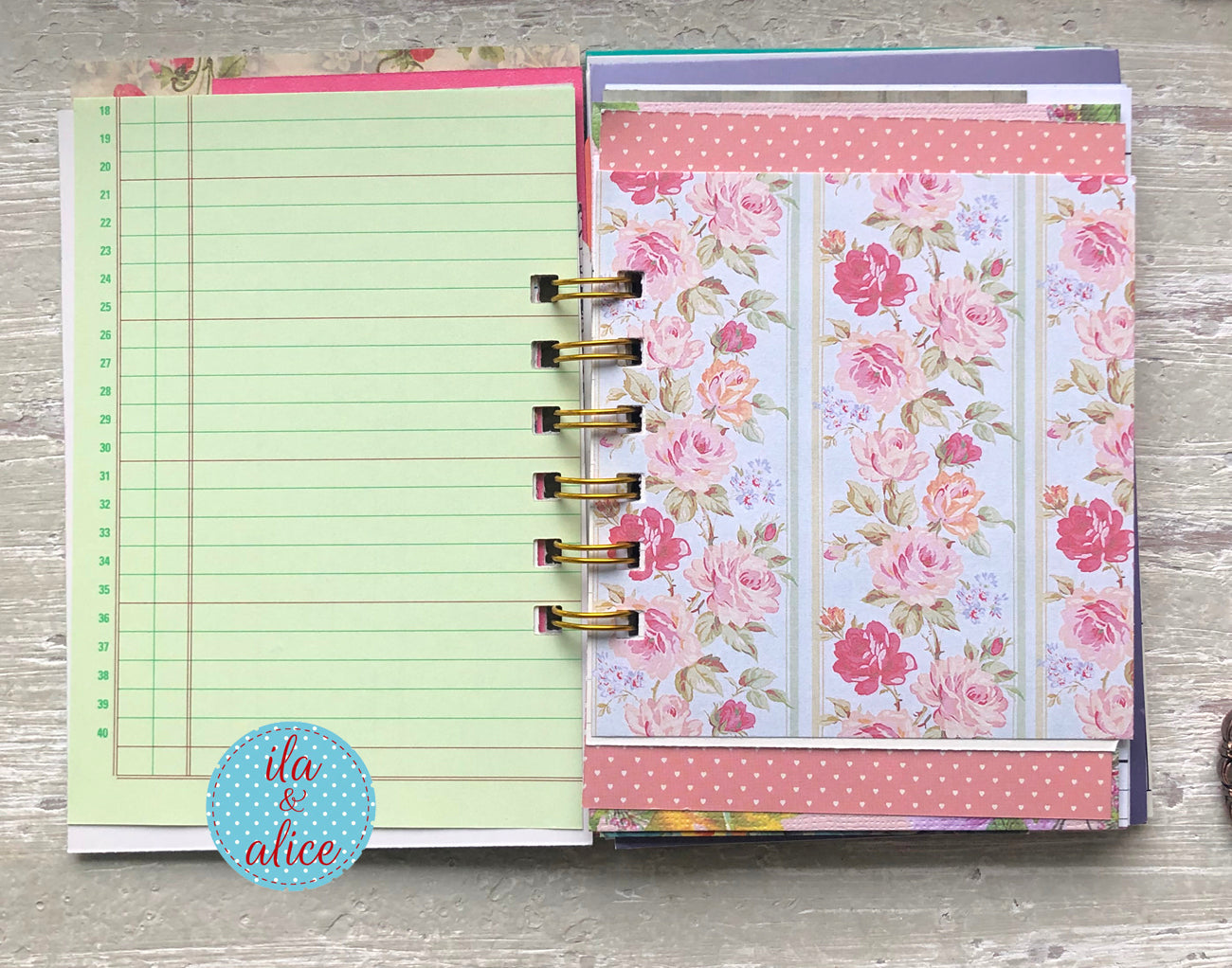 Planner with floral and checklists pages on a wooden surface