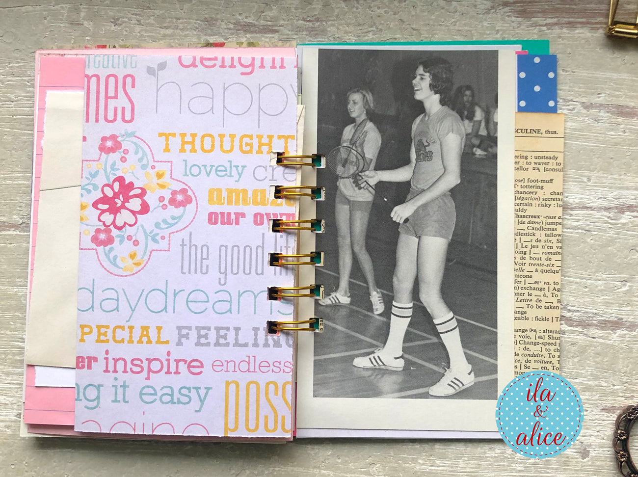 Planner with a photo of a person playing basketball and motivational text on a wooden surface.