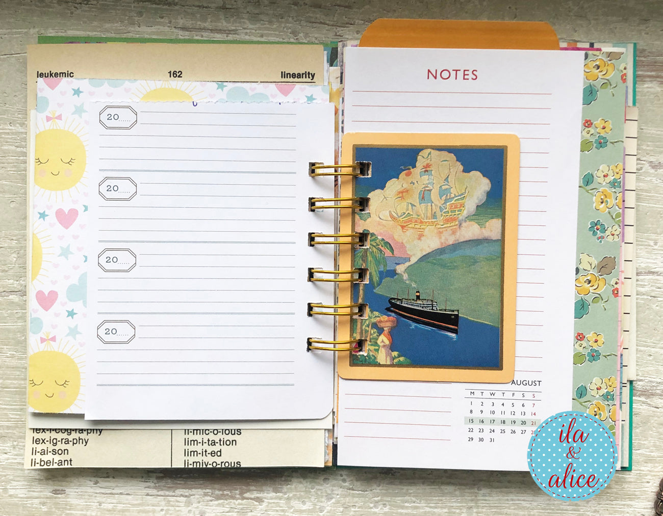 Open planner with colourful pages on a wooden surface