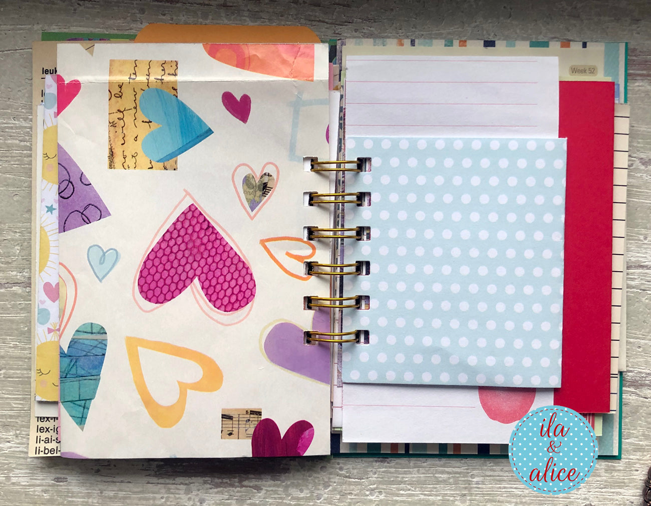 Notebook with colourful heart patterns on a wooden surface