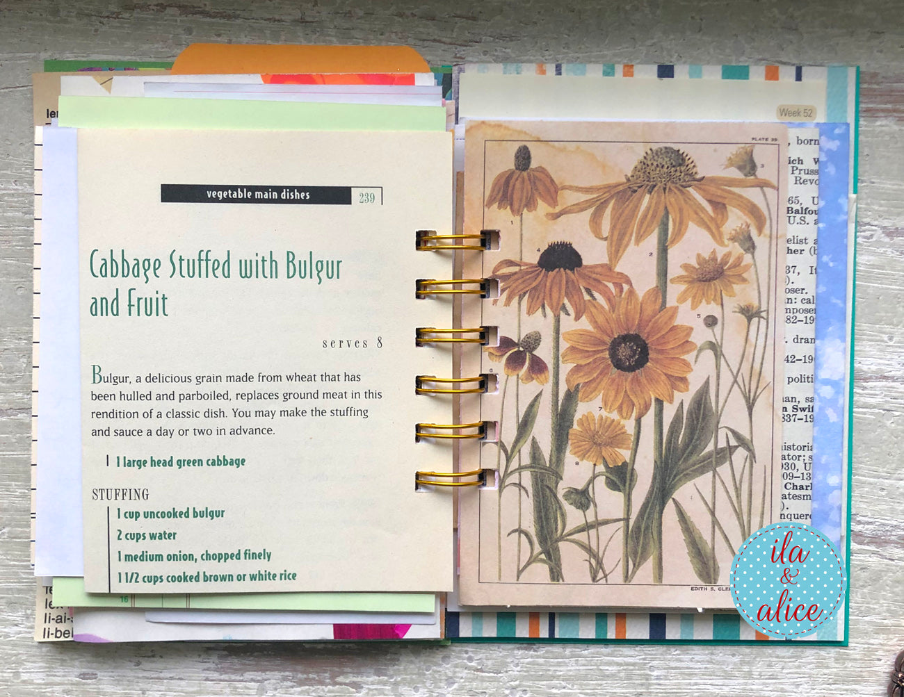 Open recipe book with floral design on a wooden surface