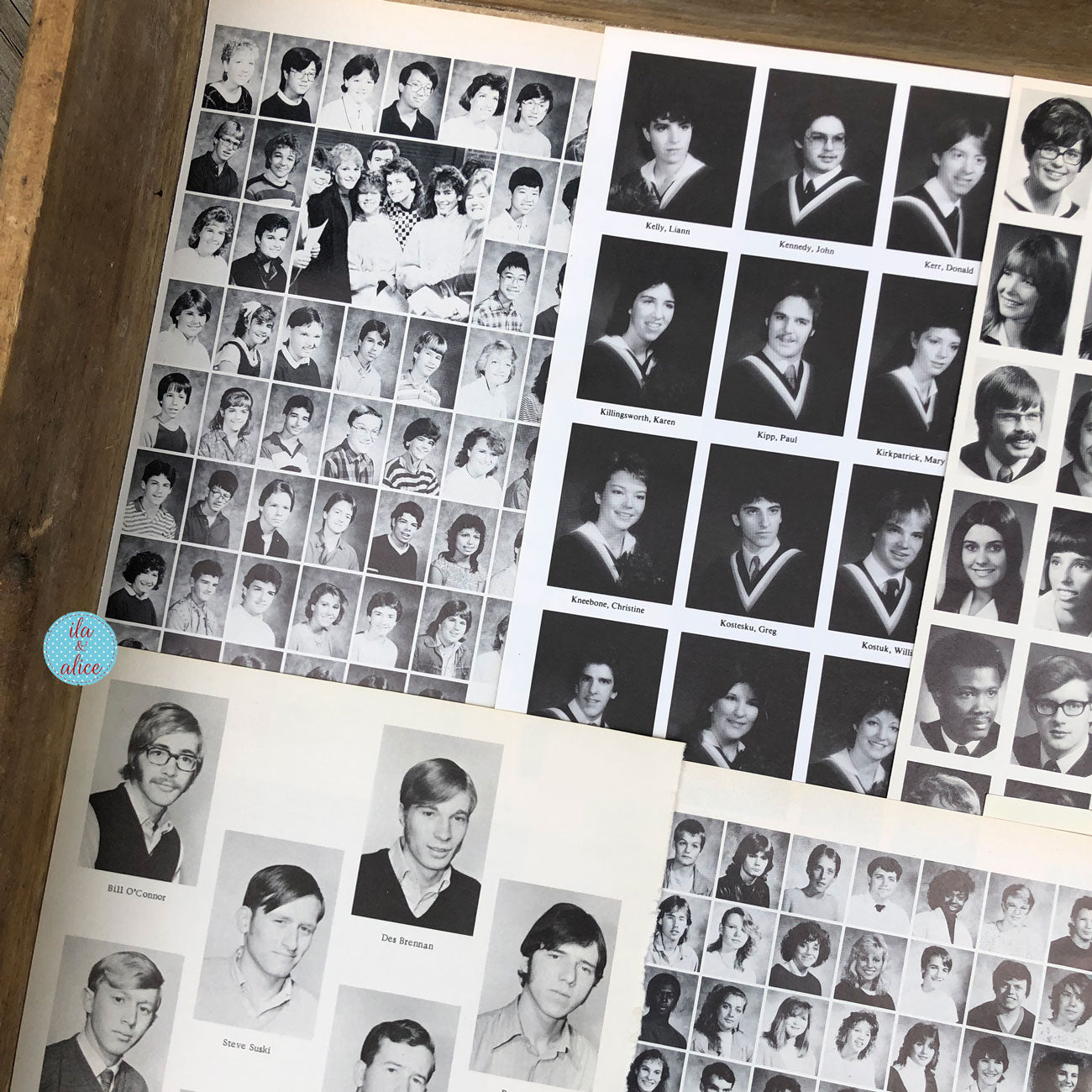 A close-up of printed yearbook pages showing many small black-and-white portrait photos of students, with some larger individual portraits and a small blue circular sticker on the left side.