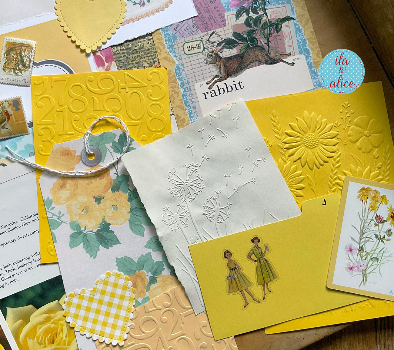curated 8x12 junk journal ephemera pack with layered papers, botanical elements, and tuckable pieces. yellow theme.