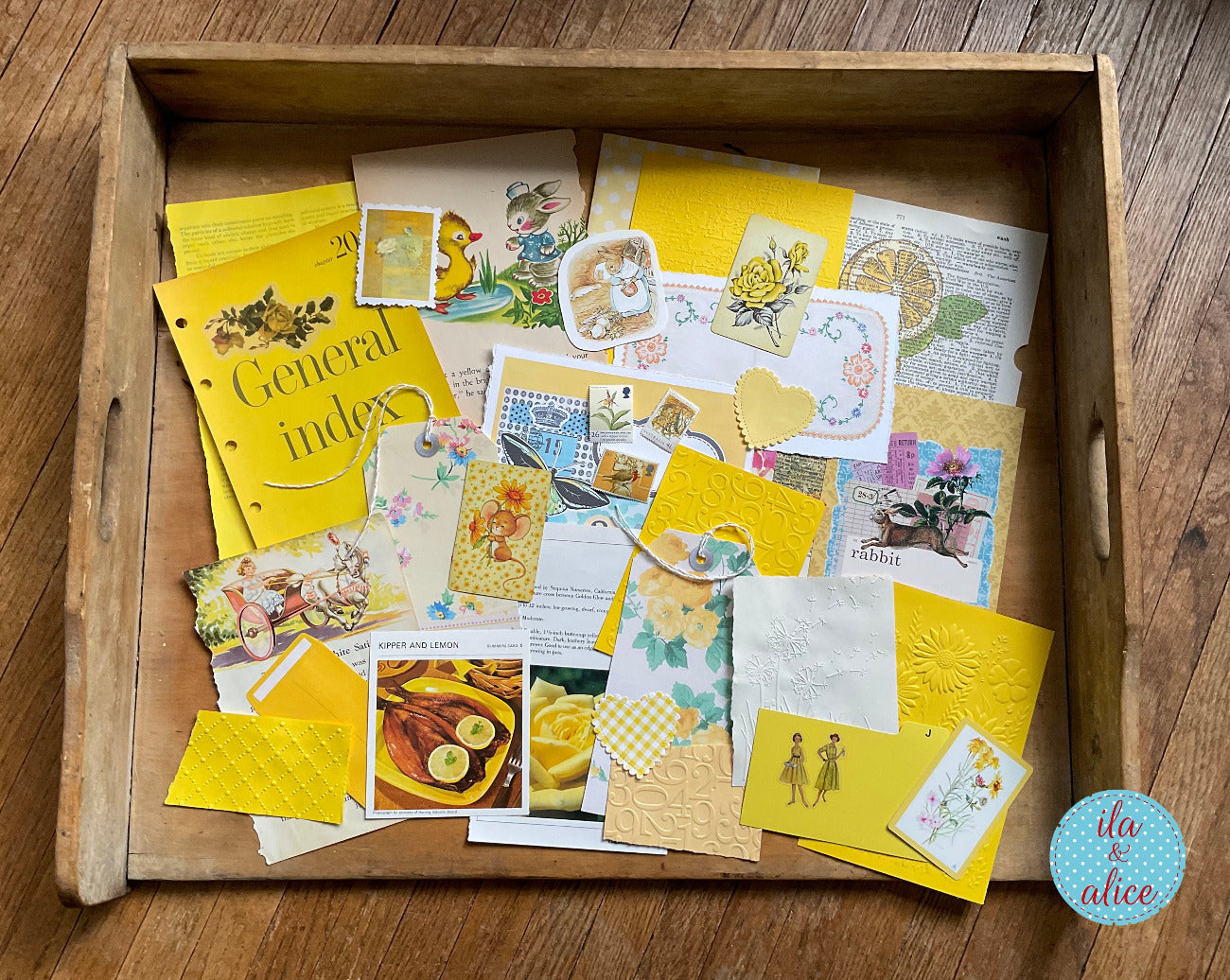 curated 8x12 junk journal ephemera pack with layered papers, botanical elements, and tuckable pieces. yellow theme.